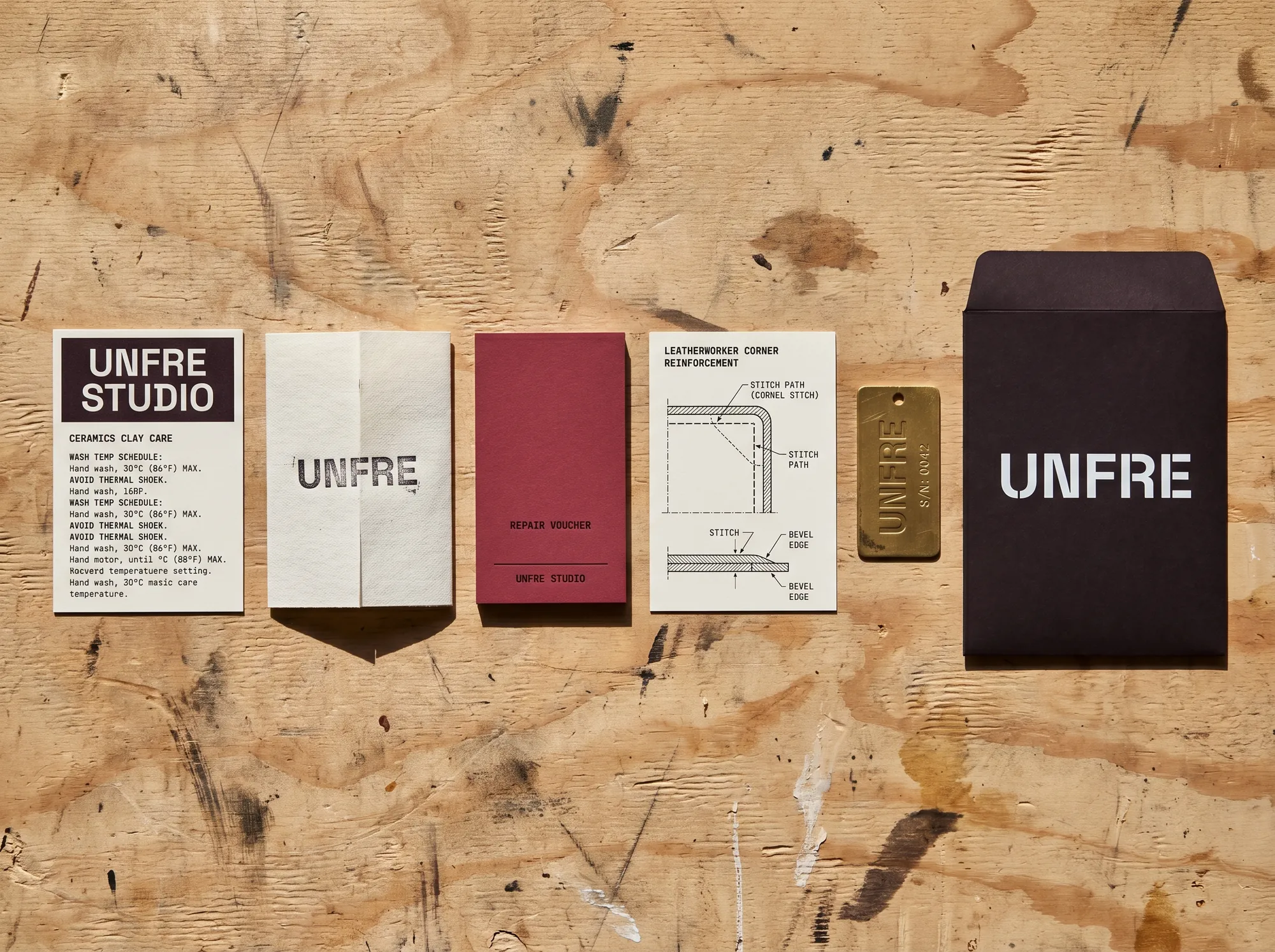 Unfre Studio Cards (Studio & Creative Working Apparel) — A boxed care-and-repair card set for the working studio — clay-and-glaze care, letterpress-cuff replacement, leatherworker-corner reinforcement diagrams.